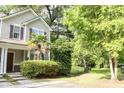 Beautiful townhome with a well-kept yard featuring lush greenery and a charming palm tree at 107 Twin Tree Dr, Summerville, SC 29485
