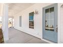 Inviting front porch with white columns, a blue front door, and shiplap siding at 109 Battle Boat Blvd, Summerville, SC 29485