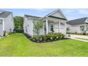 Well-maintained home with a manicured lawn, beautiful flower beds, and a two-car garage at 110 Bloomfield St, Summerville, SC 29486