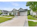 Well-maintained home with light blue siding, a landscaped front yard, and a two-car garage at 110 Bloomfield St, Summerville, SC 29486