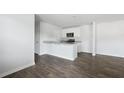 Open living area with wood floors and a granite countertop at 125 Mims Academy Dr, Harleyville, SC 29448