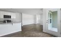 Bright, open-concept living space featuring wood floors and a patio door at 125 Mims Academy Dr, Harleyville, SC 29448