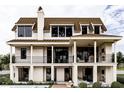 Beautiful home with a large covered patio, balconies, a pool, and a brick patio perfect for entertaining at 13 Trumbo St, Charleston, SC 29401