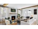 Bright living room featuring a cozy fireplace and comfortable seating arrangement with wood beam accents at 148 Falaise St, Charleston, SC 29492