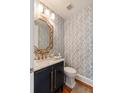 Powder bath featuring blue wallpaper, marble countertop and ornate gold framed mirror at 158 Mary Ellen Dr, Charleston, SC 29403