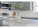 The kitchen island is staged with floral accents, plates, and a cozy eat-in dining arrangement at 1738 Us-52, Moncks Corner, SC 29461