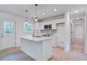 Bright kitchen featuring a center island, white cabinets, and modern appliances at 2135 Clayton St, Charleston, SC 29414