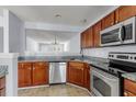 Kitchen featuring granite counters, wood cabinets and stainless steel appliances at 230 Darcy Ave, Goose Creek, SC 29445