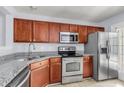 Modern kitchen with stainless steel appliances, granite counters, and wood cabinets at 230 Darcy Ave, Goose Creek, SC 29445