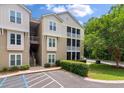 A tan condo building featuring screened in balconies and lush green landscaping at 2632 Egret Crest Ln, Charleston, SC 29414