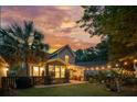 Private backyard featuring a patio, a garden, landscape lighting and mature trees at 2900 Split Hickory Ct, Johns Island, SC 29455