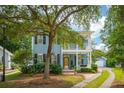 Beautiful two-story home with double porches, lush landscaping, and a private driveway at 2900 Split Hickory Ct, Johns Island, SC 29455