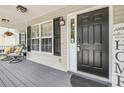 Close up of front porch with chairs and view of front door at 3061 Penny Ln, Johns Island, SC 29455