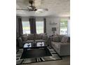 Cozy living room with ceiling fan, neutral-toned couches, and natural light, perfect for relaxing at 307 Glen St, Summerville, SC 29483