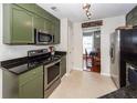 Functional kitchen with green cabinets, black countertops, and stainless steel appliances, offering practicality at 3092 Morningdale Dr, Mount Pleasant, SC 29466