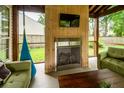 Comfortable outdoor space with a fireplace, TV, and cozy green furniture for relaxation and entertainment at 3092 Morningdale Dr, Mount Pleasant, SC 29466