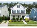 Inviting two-story home with a covered front porch, landscaped garden, and charming curb appeal at 3203 Moonlight Dr, Charleston, SC 29414