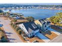 Beautiful aerial view of lakeside neighborhood homes, showcasing meticulous landscaping and waterfront amenities at 3278 Great Egret Dr, Johns Island, SC 29455