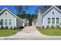 Neighborhood street view showcasing a paved drive, manicured lawns, and the architectural styles of homes in the community at 340 Trailmore Ln, Summerville, SC 29486
