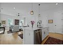 Open-concept living room with view of kitchen, hardwood floors, and neutral tones; bright and airy at 48 Aiken St, Charleston, SC 29403