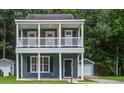 Charming two-story home with double porches, complemented by a well-maintained yard and inviting curb appeal at 4818 Buttercup Way, Summerville, SC 29485