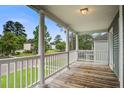 Relaxing porch view overlooking the community, showcasing green lawns and mature trees on a sunny day at 4818 Buttercup Way, Summerville, SC 29485