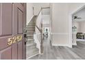 Elegant foyer with hardwood floors and a staircase leading to the upper level, showcasing a bright and open layout at 5257 Mulholland Dr, Summerville, SC 29485