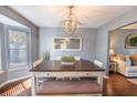 Inviting dining room featuring a modern chandelier, neutral gray walls, and a sunlit window at 529 Laurel Ridge Rd, North Charleston, SC 29418