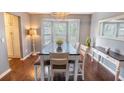 Dining room showcases a sleek table, stylish chairs, a modern chandelier, and a large bay window at 529 Laurel Ridge Rd, North Charleston, SC 29418