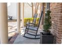 Charming front porch with rocking chairs and decorative potted plants next to the brick house at 529 Laurel Ridge Rd, North Charleston, SC 29418