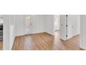Bright, airy living room featuring light wood floors and crisp white walls, ready for personal touches at 5375 Highway 174, Adams Run, SC 29426