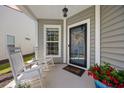 Inviting front porch featuring rocking chairs, and a welcoming front door with a wreath at 546 Sea Foam St, Summerville, SC 29486