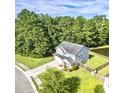 Aerial view of a lovely home with a well manicured lawn and bordered by mature trees at 610 Knowledge Dr, Ladson, SC 29456
