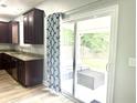 Kitchen featuring granite countertops, wood cabinets, and sliding glass door to the backyard at 610 Knowledge Dr, Ladson, SC 29456