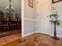 Foyer features a stone floor, a plant stand, and a partial view into a formal dining room at 7 Lavington Rd, Charleston, SC 29407