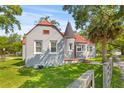 Charming home with gray brick, orange roof, turret entrance, and well-maintained lawn, surrounded by mature trees at 7 Wesley Dr, Charleston, SC 29407