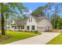 Beautifully designed two-story home with a manicured lawn, long driveway and attached garage at 727 Hodge Rd, Summerville, SC 29483