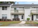 Close up of townhomes featuring trimmed bushes and an individual walkway at 7813 Sandida Ct, North Charleston, SC 29418