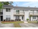 View of townhomes featuring balconies, trimmed bushes, and individual walkways at 7813 Sandida Ct, North Charleston, SC 29418