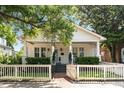 Beautiful home exterior boasting a welcoming front porch, tidy landscaping, and a charming picket fence at 814 Rutledge Ave, Charleston, SC 29403