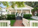 Inviting home exterior featuring a brick walkway, well-maintained lawn, and a classic covered porch at 814 Rutledge Ave, Charleston, SC 29403