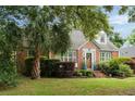 Attractive brick home with dormer windows, lush landscaping, and a well-manicured lawn at 95 Gordon St, Charleston, SC 29403
