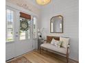 Inviting entryway features a decorative mirror, bench seating, and plank accent wall at 1004 Saltwater Cir, Johns Island, SC 29455