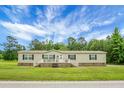 Well-kept single-story home with a quaint front porch, white railings, and dark shutters, offering a pleasant curb appeal at 1051 Cooper Store Rd, Moncks Corner, SC 29461