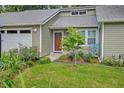 The home has mature landscaping, a metal roof, and an attached garage at 109 Willow Ct, Summerville, SC 29486