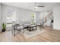 Bright living room with modern furnishings, hardwood floors, a ceiling fan, and lots of natural light at 113 Alcester Rd, Goose Creek, SC 29445