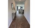 Elegant entryway featuring wood floors, a decorative mirror, and a glimpse into the open-concept living area at 116 Gaura Ln, Summerville, SC 29483