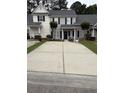 Charming townhome with neutral siding, black shutters, and a spacious concrete driveway at 123 Lynches River Dr, Summerville, SC 29485