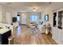 Open-concept living room featuring hardwood floors, neutral walls, and ample natural light at 123 Lynches River Dr, Summerville, SC 29485