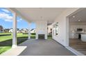Covered patio featuring a fireplace and a view of the backyard and kitchen at 137 Summerwind Dr, Summerville, SC 29486